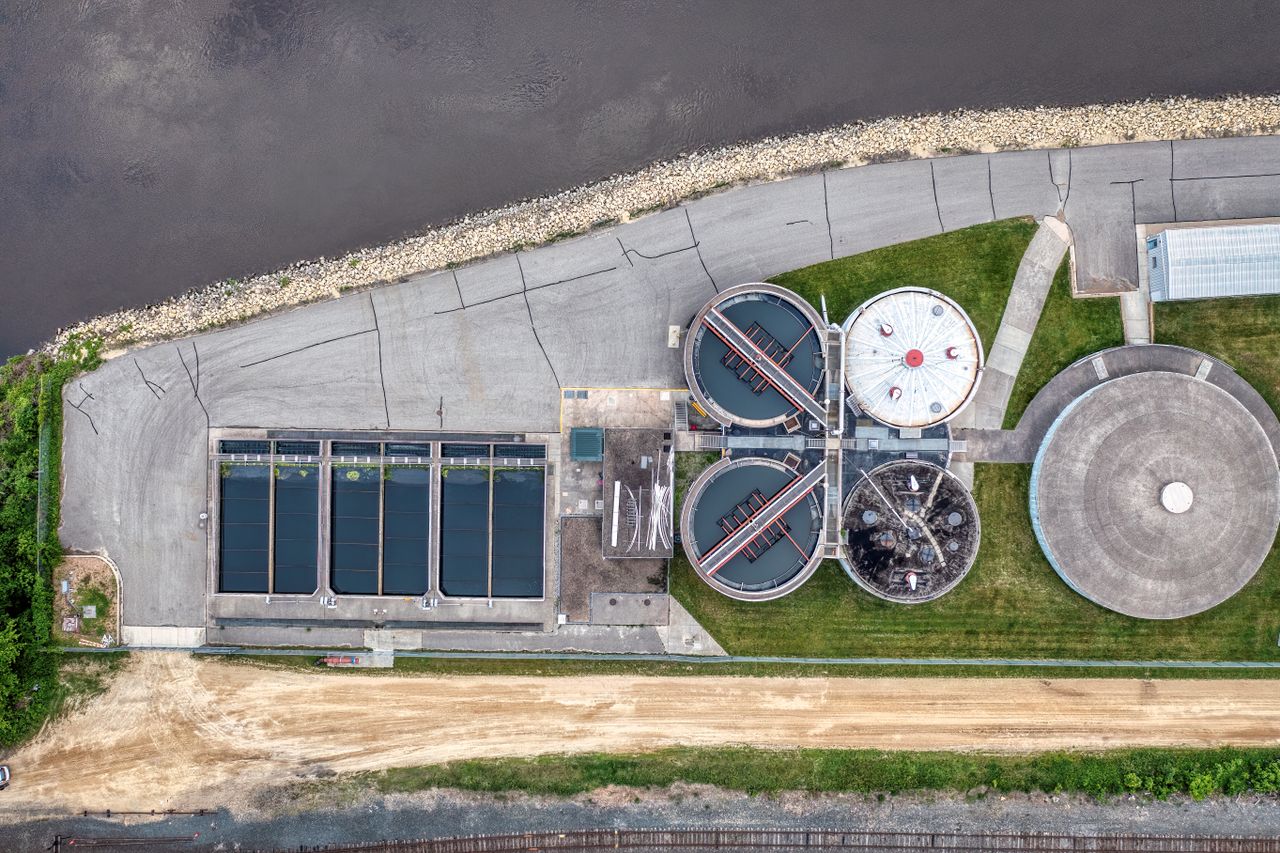 Home Top-down aerial view of a water treatment plant in Red Wing, MN near a river.